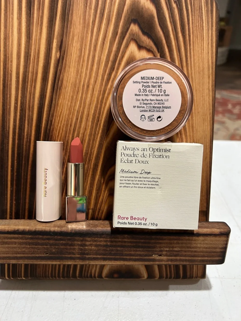Rare Beauty lipstick and setting powder in medium-deep